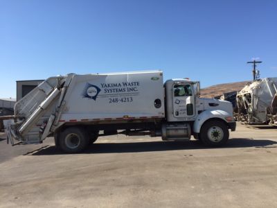 akima Waste Systems rear load garbage truck.
